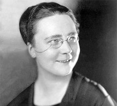 an old black and white photo of a woman wearing glasses