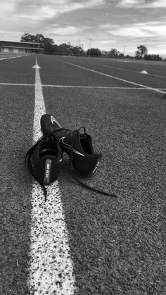 a black and white photo of a pair of shoes on the side of an airport runway