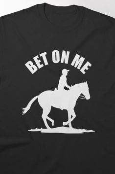 Bold horse riding t-shirt featuring the dynamic phrase 'Bet On Me' with a jockey on horseback, capturing the excitement of the race. Perfect for horse racing enthusiasts who want to showcase their passion and confidence in style. On Horseback, The Race, Victorious