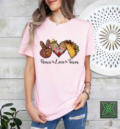 Peace Love Tacos Shirt,Funny Taco Tshirt,Taco Lover Gift,Taco Tuesday,Mexican Food Shirt,Cinco De Mayo Gift,Festival Clothing,Mexican Womens HOW TO ORDER 1. From the two Drop-down menus select the Size and the Shirt Color you need. 2. Add these to your cart. *You will need to return to the listing to add the other sizes and designs you need before checking out. 3. After adding all the shirts to the Cart, Checkout them together. DELIVERY & RETURN Order Processing time for Dispatch: 1 working days. ORDER CANCELLATIONS We accept cancellations within 6 hours of placing the order. You can message or email us from your seller account to request cancellation. RETURNS & EXCHANGES Because of the nature of these items, unless they arrive damaged or defective, we can't accept returns for personalized Cinco De Mayo Graphic Tee With Short Sleeves, Cinco De Mayo Graphic T-shirt, Casual Short Sleeve Shirt For Cinco De Mayo, Cinco De Mayo Funny Print Crew Neck T-shirt, Casual Cinco De Mayo T-shirt With Funny Print, Casual T-shirt With Funny Print For Cinco De Mayo, Casual Graphic Print Tops For Cinco De Mayo, Funny Print Short Sleeve Shirt For Cinco De Mayo, Casual Cinco De Mayo Graphic T-shirt