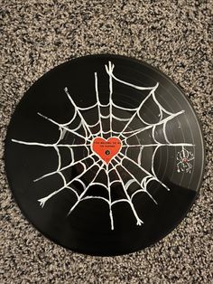 a black record with a spider web on it