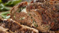 meatloaf on a plate with spinach leaves in the background