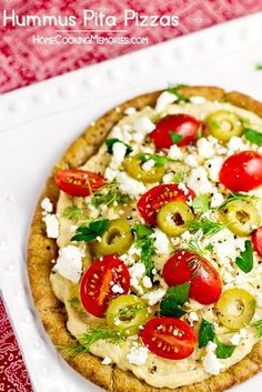 a pizza topped with tomatoes, olives and feta cheese