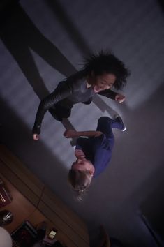 two people standing next to each other in the air with their hands on their hipss