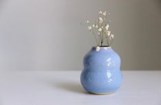 a blue vase with white flowers in it