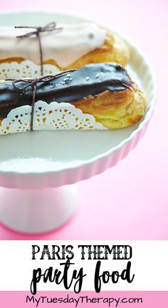 two pastries sitting on top of a white plate with black and white icing