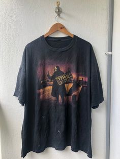 a t - shirt hanging up against a wall