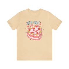 This charming tee takes inspiration from the past, featuring a delightful retro cake design and a sweet message that's perfect for expressing affection. Whether you're enjoying a romantic date or simply spreading love vibes wherever you go, this tee is a delightful addition to your Valentine's Day wardrobe. The retro charm and sweet message make it a versatile piece that can be worn with jeans, skirts, or your favorite cozy loungewear. T-Shirt Material + Fit - 100% Airlume combed and ring-spun c Valentine Graphic Tee, Sweet Graphic Print Birthday T-shirt, Sweet Graphic Print T-shirt For Birthday, Sweet T-shirt For Summer Gift, Sweet Summer T-shirt As Gift, Vintage T-shirt With Funny Print For Birthday, Sweet Crew Neck T-shirt For Gift, Sweet Letter Print T-shirt For Gift, Retro Cake Design