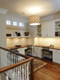 an open concept kitchen with white cabinets and wood flooring is featured in this image