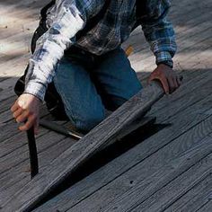 a man kneeling down with a knife in his hand