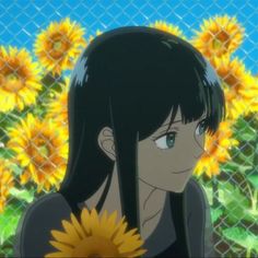 a woman with long black hair standing in front of sunflowers