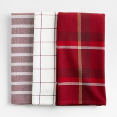 three red and white plaid napkins on top of each other, one folded in half