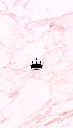 a white marble wall with a black crown on the top and two dots in the middle