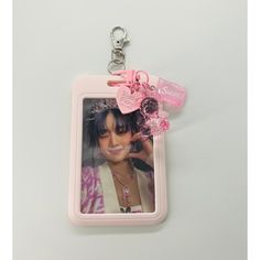 a keychain with a photo on it and a pink ribbon attached to it