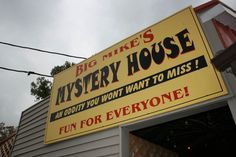 a big sign on the side of a building that says big mike's mystery house