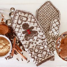 two brown oven mitts sitting on top of a table next to cinnamons and spices