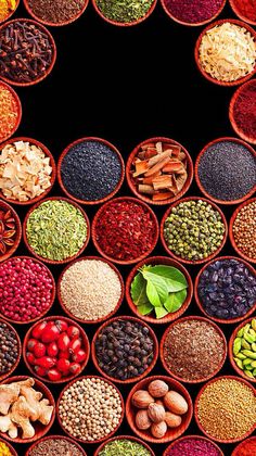 many bowls filled with different types of spices and nuts, all arranged in the shape of a circle