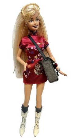 a barbie doll dressed in a red dress holding a purse