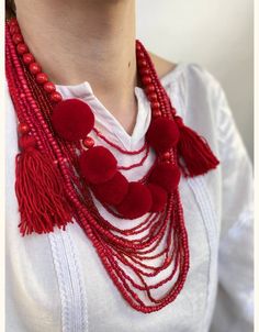 Necklace with Tassels and Beads: a unique designer approach to jewelry creation. Woolen and wooden beads, when combined, create the effect of forest warmth and natural coziness. The tassels at the ends have a delicate appearance and allow for adjusting the length of the necklace. This authentic accessory will undoubtedly become your favorite addition to both casual and festive outfits. The necklace is crafted from high-quality materials and features a sturdy construction, ensuring its durability Unique Wooden Beaded Necklaces, Elegant Beaded Necklace With Wooden Beads, Long Beaded Necklace With Tassels As Gift, Red Tassel Necklaces As Gifts, Red Tassel Necklaces For Gifts, Red Tassel Necklace For Gift, Festival Beaded Necklaces With Tassels And Round Beads, Tassel Necklace With Round Beads For Gifts, Gift Beaded Necklaces With Wooden Beads