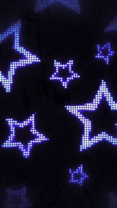 some blue and white stars are glowing in the dark