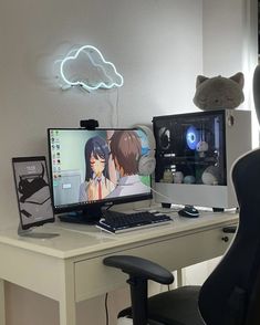 a computer desk with two monitors and a keyboard on it in front of a teddy bear