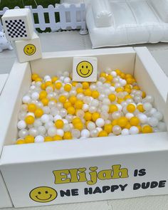 a box filled with yellow and white balloons that say enjoy is one happy dude on it