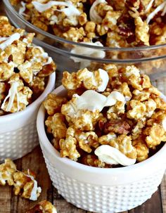 three bowls filled with caramel popcorn on top of a wooden table