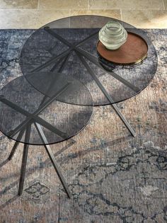 a hat is sitting on top of a glass table in the middle of a rug