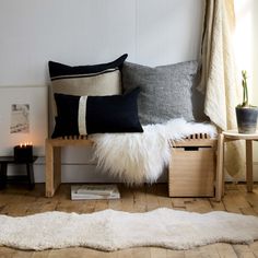 a living room with white and black pillows