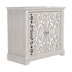 a white cabinet with an intricate design on the front and side panels, in grey wood