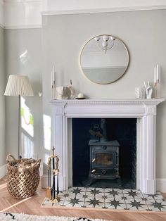 a living room with a fire place in the center and a rug on the floor