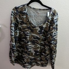 Long Sleeve Camo Printed T-Shirt From Brand Gili Or G.I.L.I. I'm Not Sure. 95% Cotton With 5% Spandex For A Comfortable Fit. Scoop Neck. Never Worn But Washed So The Tags Have Been Removed. Belonged To My Late Mother. Khaki Cotton Top For Loungewear, Fall Camouflage Tops With Graphic Print, Camouflage Crew Neck Top For Fall, Casual Camouflage Fall Tops, Casual Camouflage Crew Neck Top, Fall Camouflage Cotton Tops, Fall Camouflage Crew Neck Top, Camouflage Graphic Print Relaxed Fit Tops, Camouflage Long Sleeve Cotton Shirt