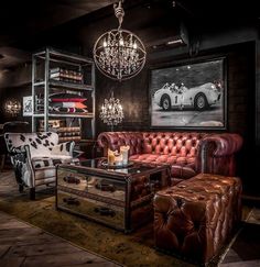 a living room filled with furniture and a chandelier hanging from it's ceiling