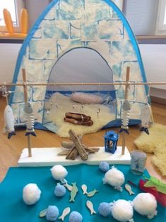 an indoor play area with toys on the floor and in front of it is a tent