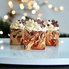 three pieces of cake sitting on top of a white plate next to a christmas tree