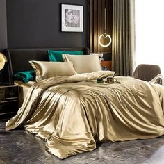 a bed covered in gold sheets and pillows