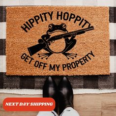 a person standing in front of a door mat that says happy hoppy get off my property