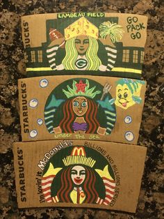 three cardboard boxes with different designs on them