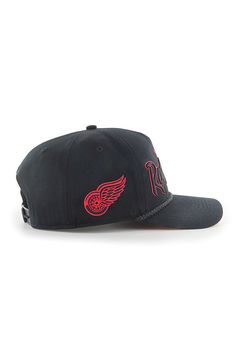 a black hat with red wings on it