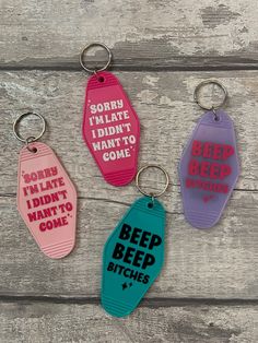 four key chains with sayings on them