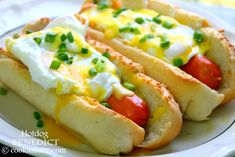 two hot dogs with mustard, ketchup and mayonnaise on a plate