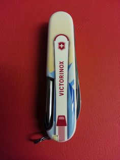 a close up of a toothbrush on a red surface with the words victory written on it