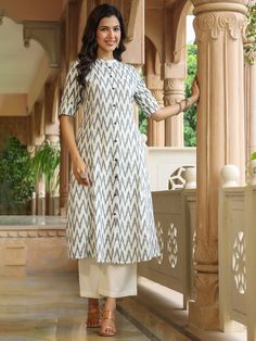 This White Ikat Print A-line Kurta from Piroh exhibits button down placket with coconut buttons details, sleeves has cuff and tab button along with Mandarin Collar & 3/4th Sleeves. Tailored from Cotton. Product Length: 45 Inches. Description Size - Measuring Unit  :  Regular Size                                 :  ( S, M, L, XL, XXL )  Shape Type                    : Straight Length Type                   :  Calf Length Color                                : White Ideal For Festive Kurta With Button Cuffs, Traditional Cotton Kurta With Button Cuffs, Festive Traditional Kurta With Button Closure, Traditional Fitted Kurta With Button Cuffs, Festive Fitted Kurta With Buttons, Fitted Festive Kurta With Buttons, Traditional Long Sleeve Dress With Buttons, Traditional Summer Dresses With Buttons, Traditional Long Sleeve Buttoned Dresses