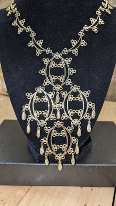 "Lovely mid-century fancy pendant necklace with gold tone filigree and dangles.  Light stamped metal but has the delicate look of Edwardian elegance.  The necklace opening is 18\" long and the pendant is 5\" tall and 3\" wide.Please check out my shop for all kinds of gift ideas. Vintage and Contemporary options: https://mrmugginsmarket.etsy.com" Fancy Pendant, Filigree Pendant Necklace, Stamped Metal, Filigree Pendant, Ideas Vintage, Metal Stamping, Pendant Necklaces, Necklace Etsy, Jewelry Necklace Pendant