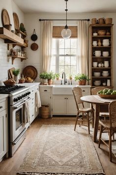 a kitchen filled with lots of white appliances and wooden shelves next to a table topped with fruit