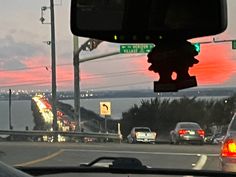 cars are driving down the road at dusk