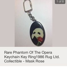 a keychain with an image of a man holding a rose in his mouth