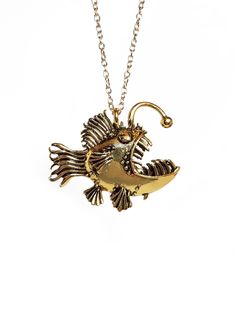 Who doesn't love angler fish?  They are unique and funky creatures that will make you laugh at the sight of them!  We bring all this uniqueness into one necklace, and we are sure you'll love it too!  The necklace weighs (1.4 ounces) because it is strong and durable.  The chain is on the gold necklace is 18 inches long, and for the silver it is adjustable from 28-31 inches.  It is made of metal alloy. Brass Jewelry With Fish Hook For Gift, Handmade Fish-shaped Jewelry Gift, Unique Jewelry With Fish Hook For Gift, Funky Creatures, Feminist Necklace, Godmother Necklace, World Map Necklace, Dove Necklace, Acorn Necklace