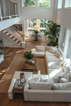 a living room filled with white furniture and lots of windows on top of each other