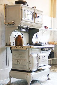 an old fashioned stove in the middle of a kitchen